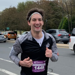 A Girls on the Run SoleMate smiling to someone off camera while working out