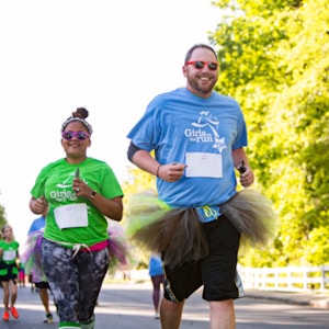 Two Girls on the Run Coaches smile while running 